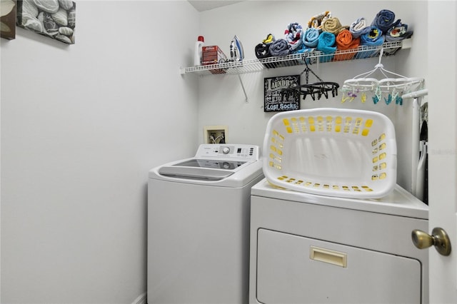 clothes washing area with washer and dryer