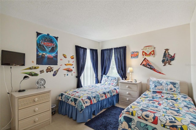 bedroom featuring a textured ceiling and carpet floors