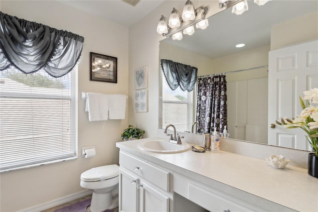 bathroom with toilet, a shower with shower curtain, and vanity