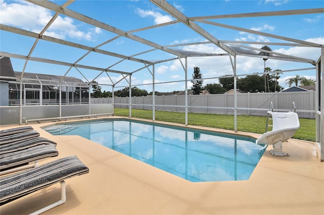 view of pool with a patio area, a lanai, and a lawn