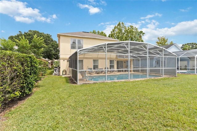 rear view of property featuring a lawn and a lanai