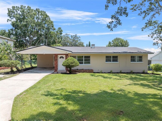 single story home with a carport and a front lawn