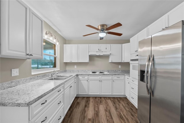 kitchen with ceiling fan, dark hardwood / wood-style flooring, white cabinetry, sink, and white appliances