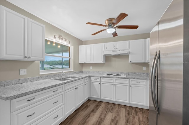 kitchen featuring white cabinetry, sink, stainless steel refrigerator, and dark hardwood / wood-style flooring