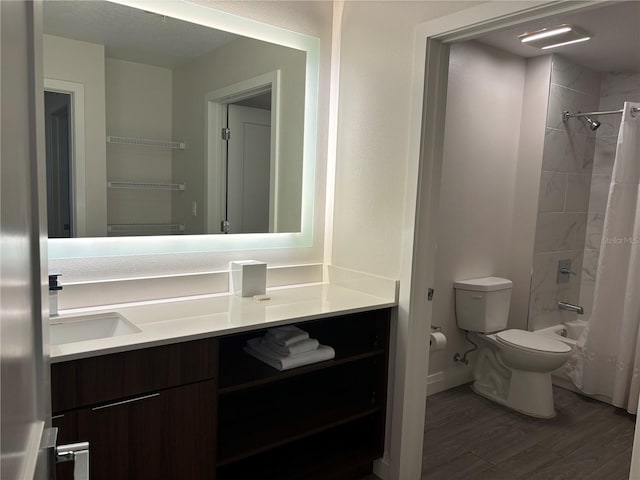 full bathroom with shower / tub combo with curtain, toilet, vanity, wood finished floors, and baseboards