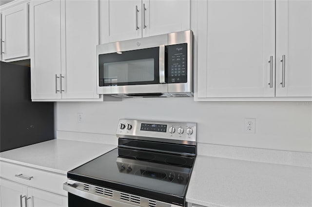 kitchen featuring white cabinets and appliances with stainless steel finishes