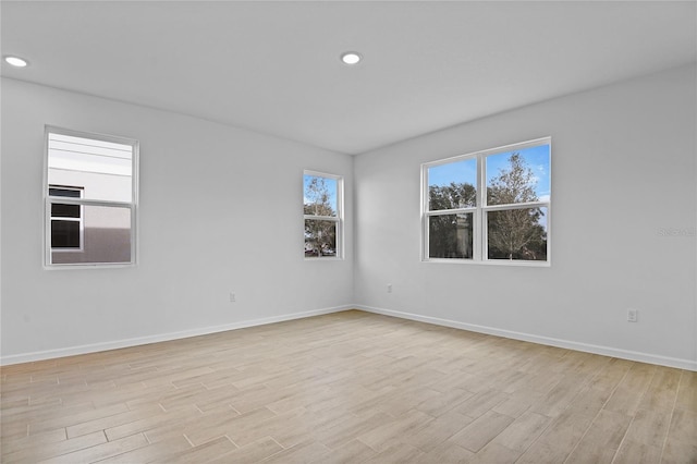 spare room featuring light hardwood / wood-style floors