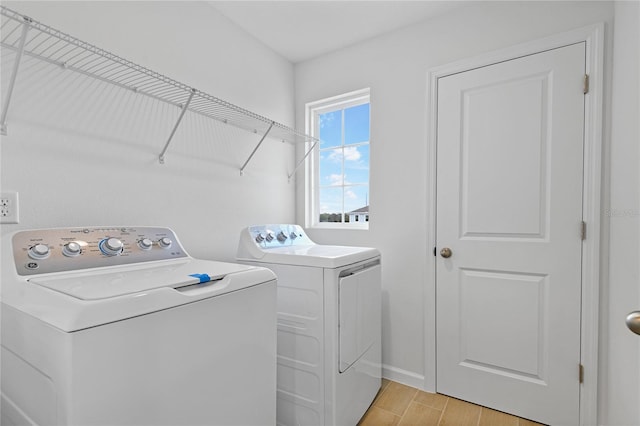 clothes washing area featuring light hardwood / wood-style floors and washing machine and clothes dryer