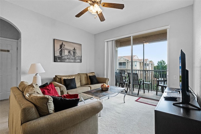 carpeted living room with ceiling fan