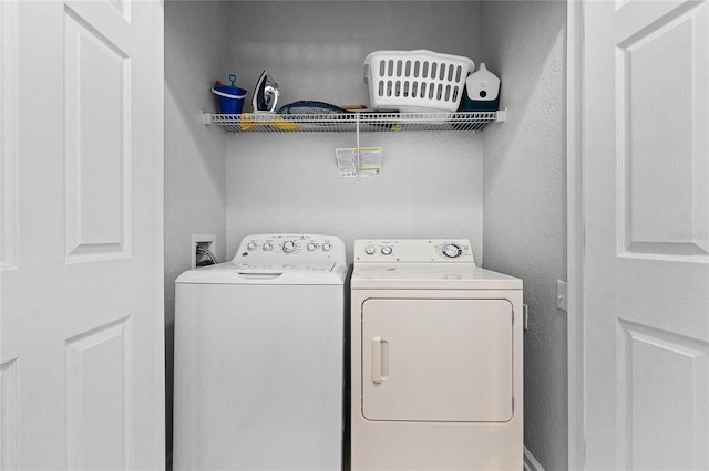 clothes washing area featuring separate washer and dryer