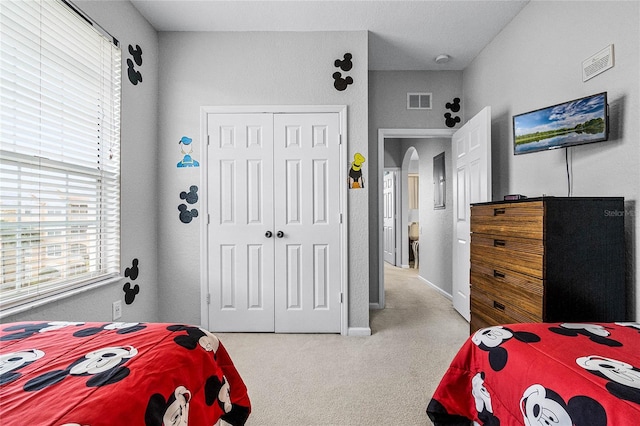 carpeted bedroom with a closet