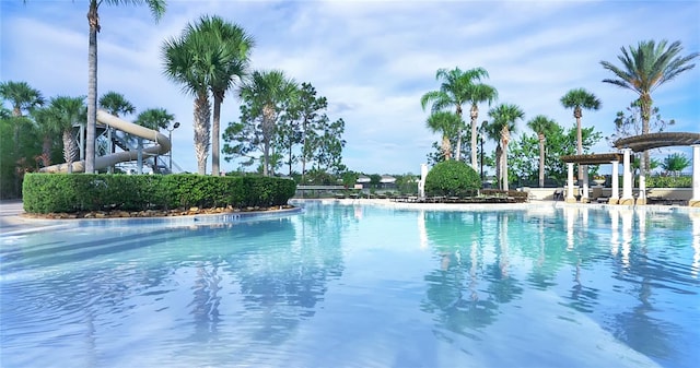 view of swimming pool with a water slide