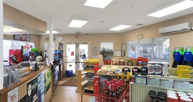 interior space with light tile patterned floors, french doors, and a wall mounted AC