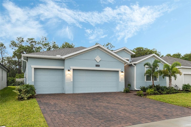 view of front of home featuring a garage and a front lawn