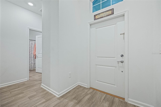 entrance foyer with baseboards and light wood-style floors