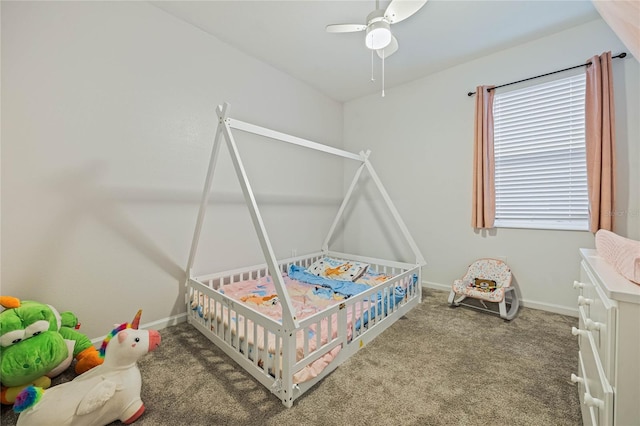 carpeted bedroom with ceiling fan and baseboards