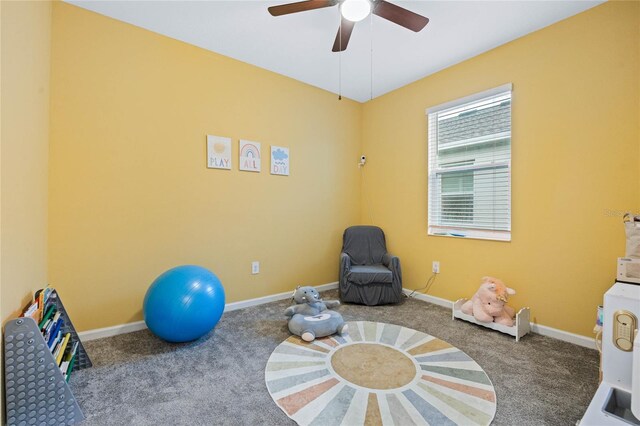 exercise area featuring carpet flooring and ceiling fan