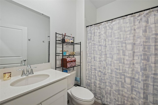 bathroom featuring curtained shower, toilet, and vanity