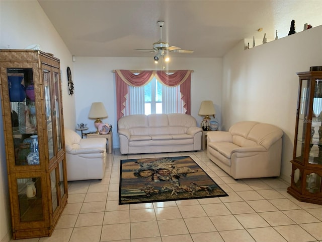 living room featuring ceiling fan, light tile patterned floors, and lofted ceiling