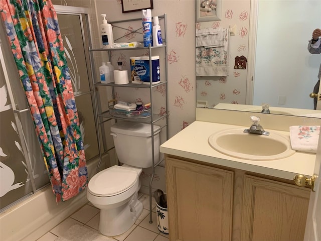 bathroom featuring tile patterned flooring, vanity, toilet, and shower / bath combo with shower curtain