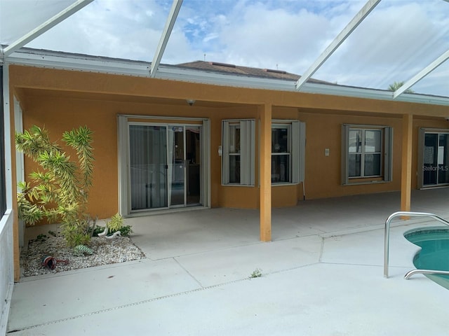 rear view of house featuring a patio and a lanai