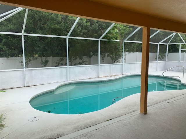 view of pool with a lanai and a patio