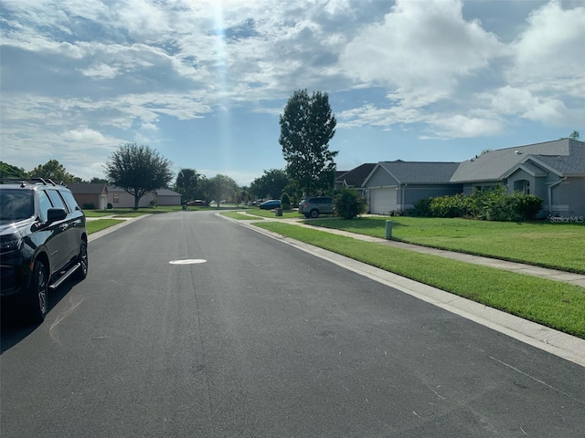 view of street featuring a residential view, curbs, and sidewalks