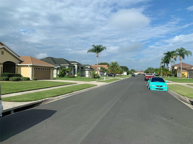 view of street featuring a residential view, curbs, and sidewalks