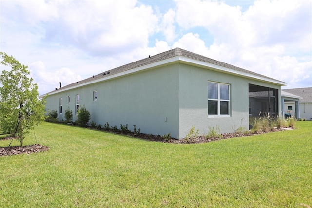 view of property exterior with a sunroom and a yard