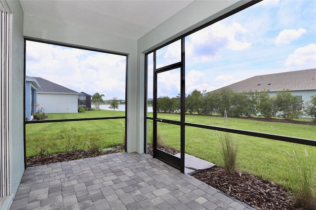 unfurnished sunroom with a water view