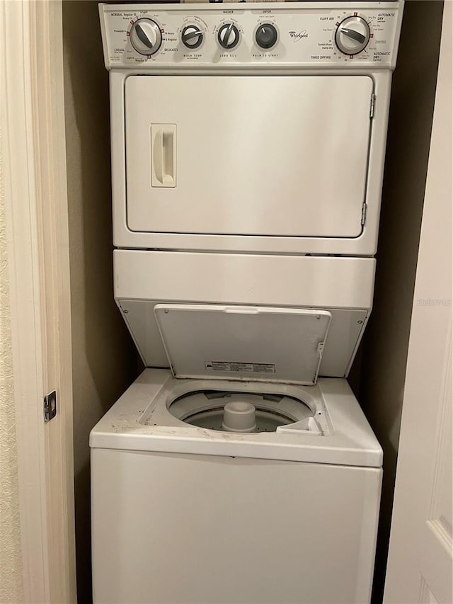 washroom with laundry area and stacked washing maching and dryer