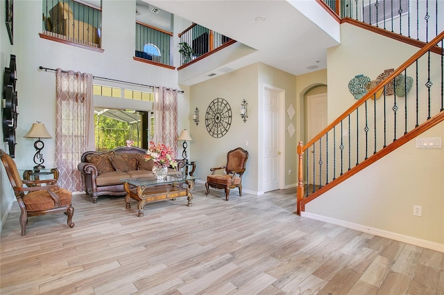 interior space featuring stairs, wood finished floors, and baseboards