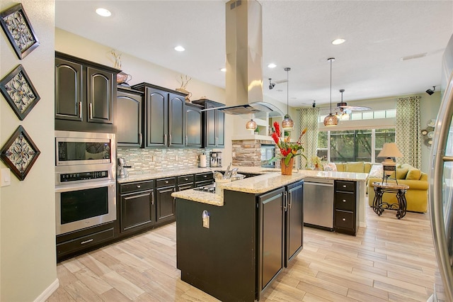 kitchen with a center island, stainless steel appliances, light stone countertops, and backsplash