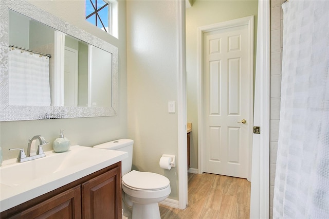 bathroom featuring a shower with shower curtain, vanity, toilet, and wood-type flooring