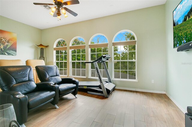 workout room featuring light hardwood / wood-style flooring and ceiling fan