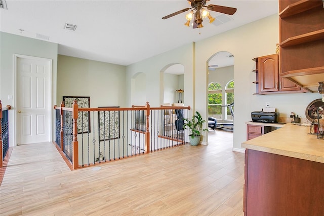 kitchen with ceiling fan and light hardwood / wood-style floors