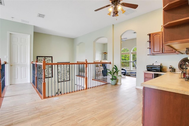 kitchen featuring open shelves, light countertops, visible vents, and light wood-style floors