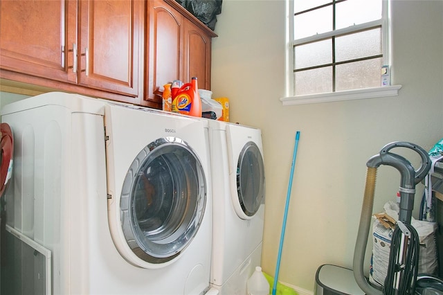 laundry area featuring cabinets and washing machine and dryer