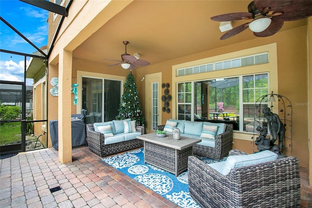 view of patio / terrace featuring a lanai, ceiling fan, and an outdoor hangout area