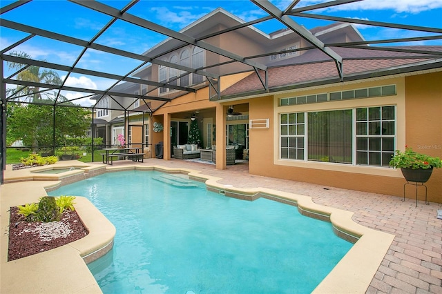 view of swimming pool featuring a ceiling fan, glass enclosure, an outdoor hangout area, a patio area, and a pool with connected hot tub