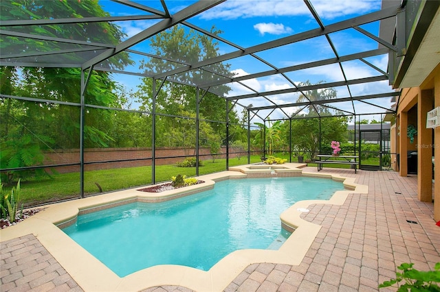 view of swimming pool featuring a patio, glass enclosure, and a pool with connected hot tub