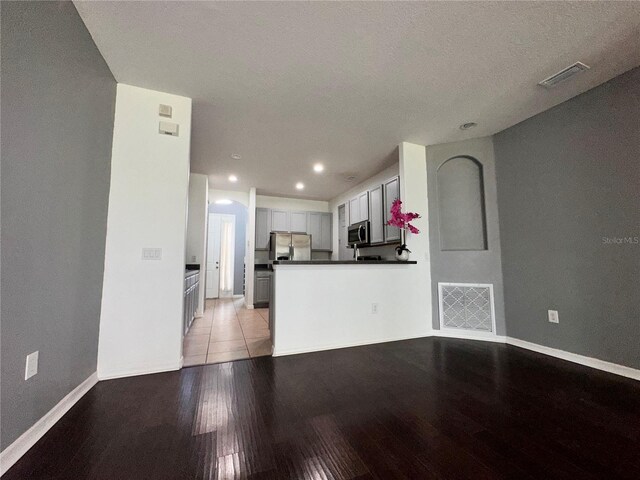 interior space featuring a textured ceiling and light hardwood / wood-style floors