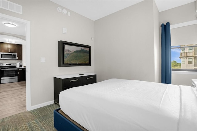 carpeted bedroom with visible vents and baseboards