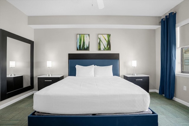 bedroom with dark carpet and baseboards