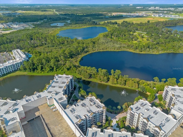 aerial view with a water view and a wooded view