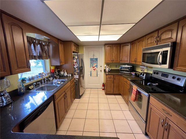 kitchen featuring light tile patterned floors, sink, and appliances with stainless steel finishes