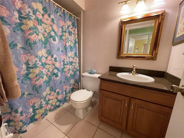 bathroom featuring tile patterned floors, walk in shower, vanity, and toilet