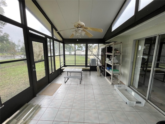 unfurnished sunroom with a healthy amount of sunlight, ceiling fan, and lofted ceiling