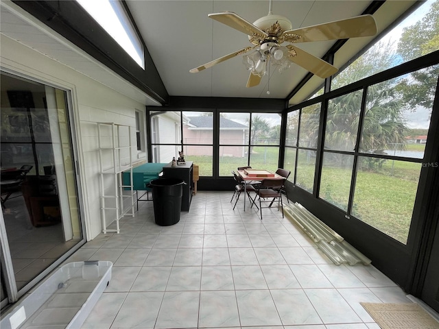 sunroom featuring ceiling fan and lofted ceiling