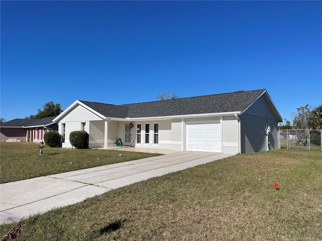 single story home with a garage and a front lawn